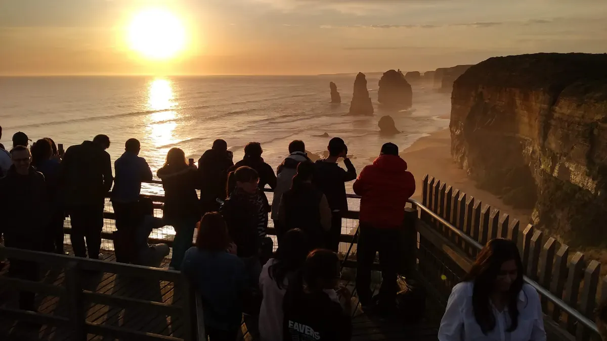 A group watching the sun set over the Twelve Apostles on the Great Ocean Road